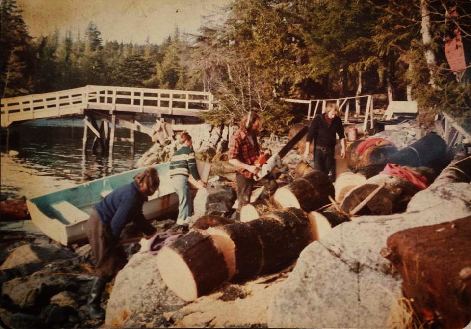 Friends cutting firewood by dock at Salt Lakes