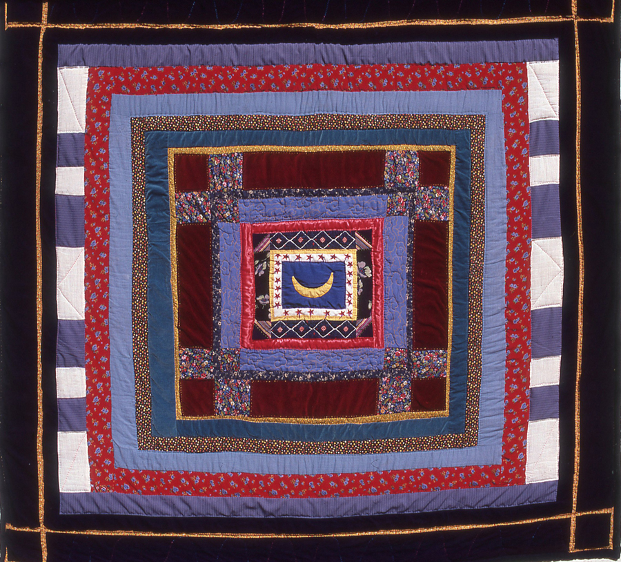 A crescent moon in the center of the quilt is bordered by stars